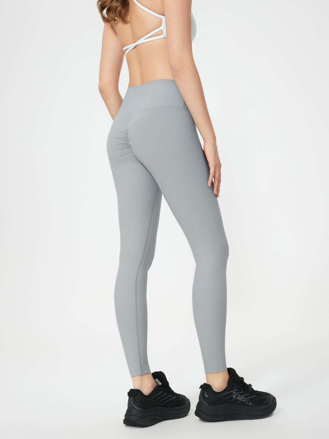 Light gray ribbed high-waist leggings with ruched butt detail.