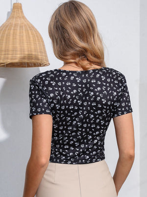 Black floral print crossover crop top with short sleeves.