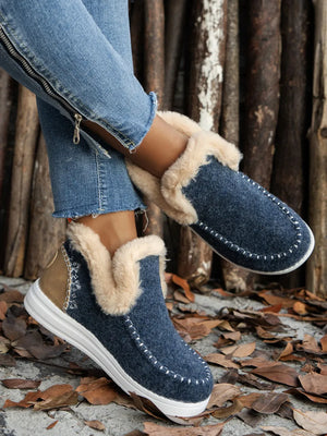 Navy felted slippers with faux fur trim and stitch detail.