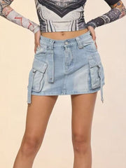 Plus size light wash denim cargo skirt with button closure and utility pockets.