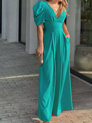 Teal romper with puff sleeves, deep V-neck, cinched waist, and wide legs.