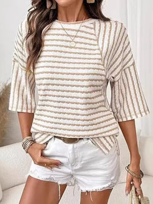Wavy stripe knit t-shirt with relaxed fit and 3/4 sleeves in a beige and white stripe pattern.