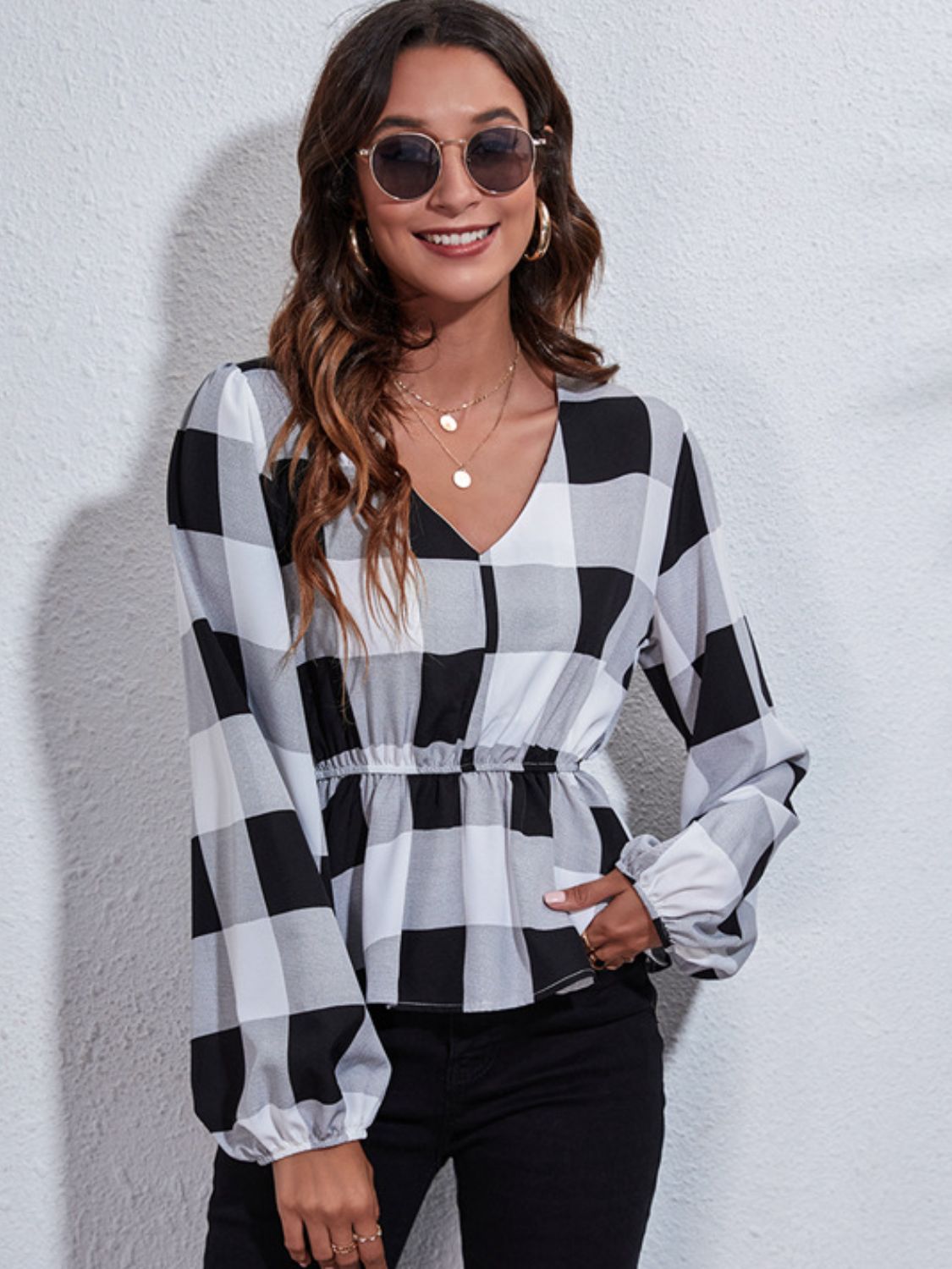 Gingham peplum blouse with gathered waist in black and white plaid, V-neck, long sleeves