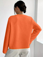 Orange textured fleece button-up jacket with contrast trim