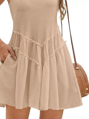 Apricot frill tiered mini dress with pockets and a V-shaped ruffled hem.