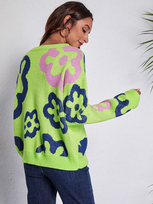 Neon floral knit crewneck sweater in light green with navy and pink abstract flower pattern.