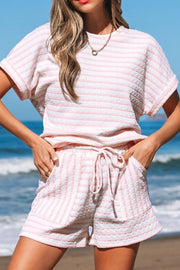 Textured stripe lounge set in blush pink with drawstring shorts and short sleeve top.