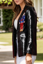 Black sequin blazer with nutcracker appliqué and single button closure.
