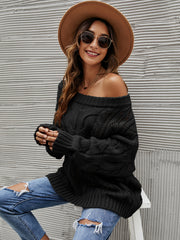 Black cable knit off-shoulder slouch sweater with a relaxed fit.