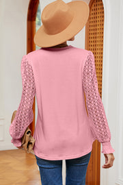 Blush pink knit top with lace sleeves and smocked cuffs.