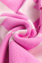 Fuchsia pink and white checkered knit polo sweater with button detail