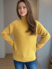 Yellow ribbed turtleneck sweater with raglan sleeves.