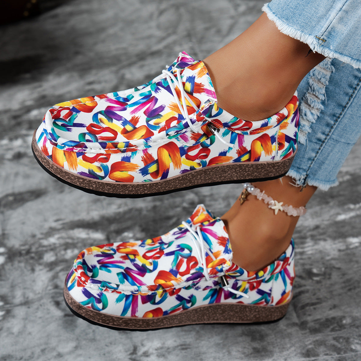 Printed casual slip-on loafers with abstract brushstroke pattern in white and multicolor.