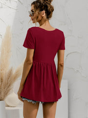 Burgundy V-neck tee with gathered waistline and short sleeves, styled with denim shorts.