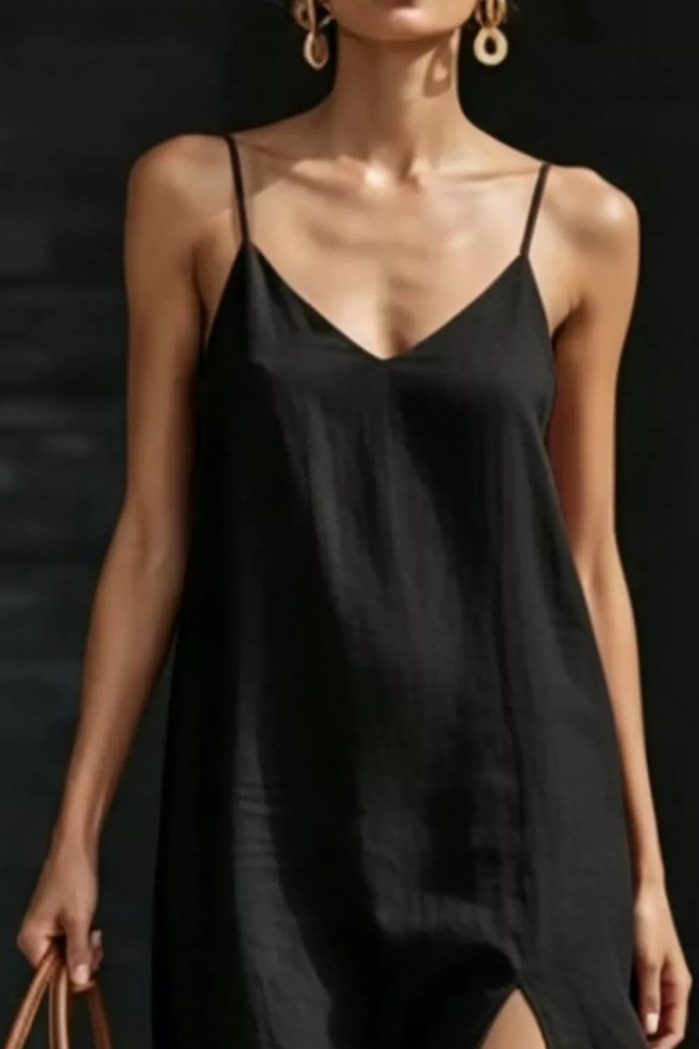 Black V-neck maxi dress with spaghetti straps and a side slit.