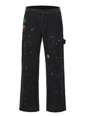 Black carpenter trousers with artisan paint splatters and bootcut leg.