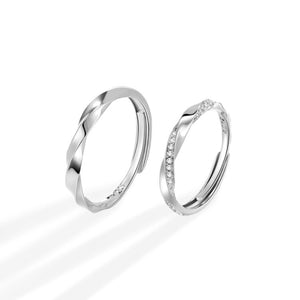 Adjustable sterling silver rings, one plain twisted band, one with pave zircon details.