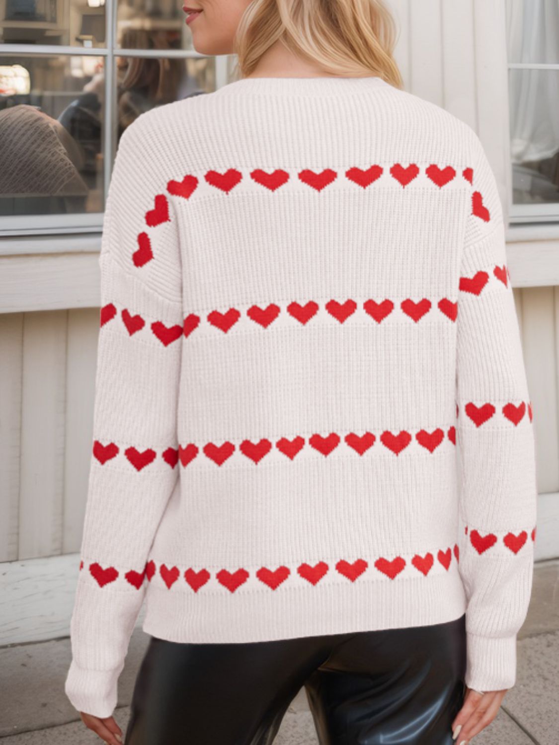 Ivory knit sweater with red heart stripes, crew neck, long sleeves.