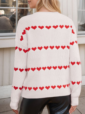 Ivory knit sweater with red heart stripes, crew neck, long sleeves.