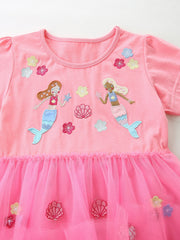 Pink cotton toddler dress with mermaid embroidery and a pink tulle skirt.