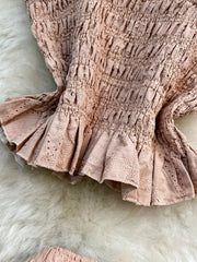 Pink eyelet crop top with ruffled hem and matching maxi skirt detail