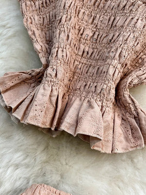Pink eyelet crop top with ruffled hem and matching maxi skirt detail