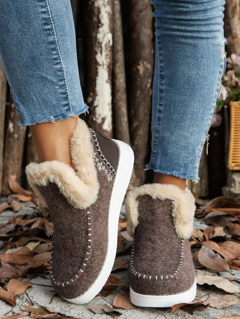 Chocolate felted slippers with faux fur trim and white stitch detail.