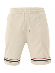 Apricot textured knit drawstring shorts with pockets and striped hem