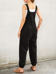 Black cotton overalls jumpsuit with a heart pocket detail and cuffed ankles.