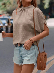 Textured dot back-tie blouse in cream with split sleeves and mock neck.
