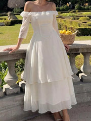 Elegant cream off-shoulder midi dress with ruffled neckline and tiered skirt