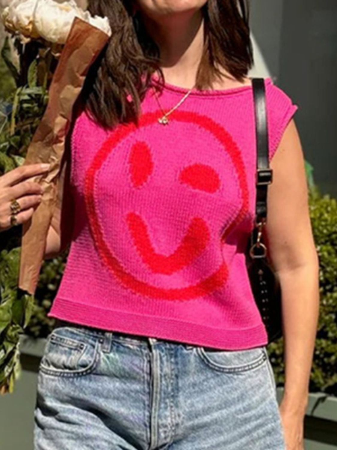 Pink knit tank top with red smiley face detail and cap sleeves.