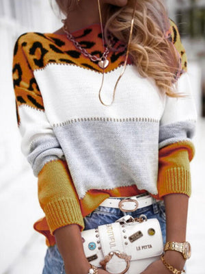 Leopard panel knit sweater with colorblock white, gray, and gold sleeves.