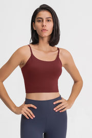 Rust scoop neck crop tank top with spaghetti straps.
