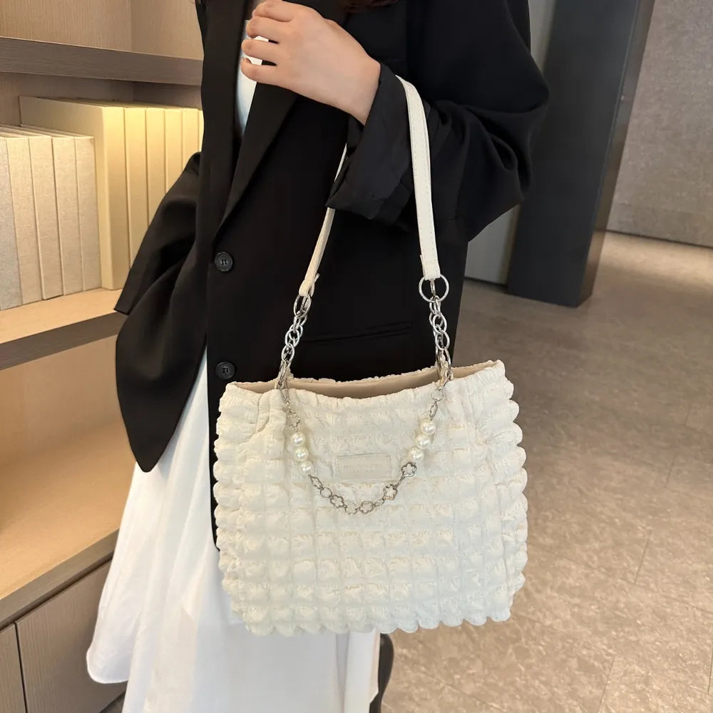 Textured grid pearl chain tote bag in ivory with chain and pearl strap detail.