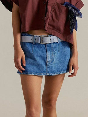 Classic denim mini skort in light blue with button closure and a grey belt.