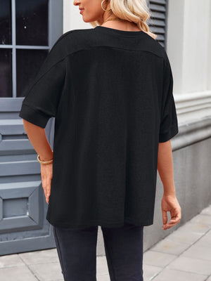 Black relaxed fit t-shirt with short dolman sleeves and a crew neck.