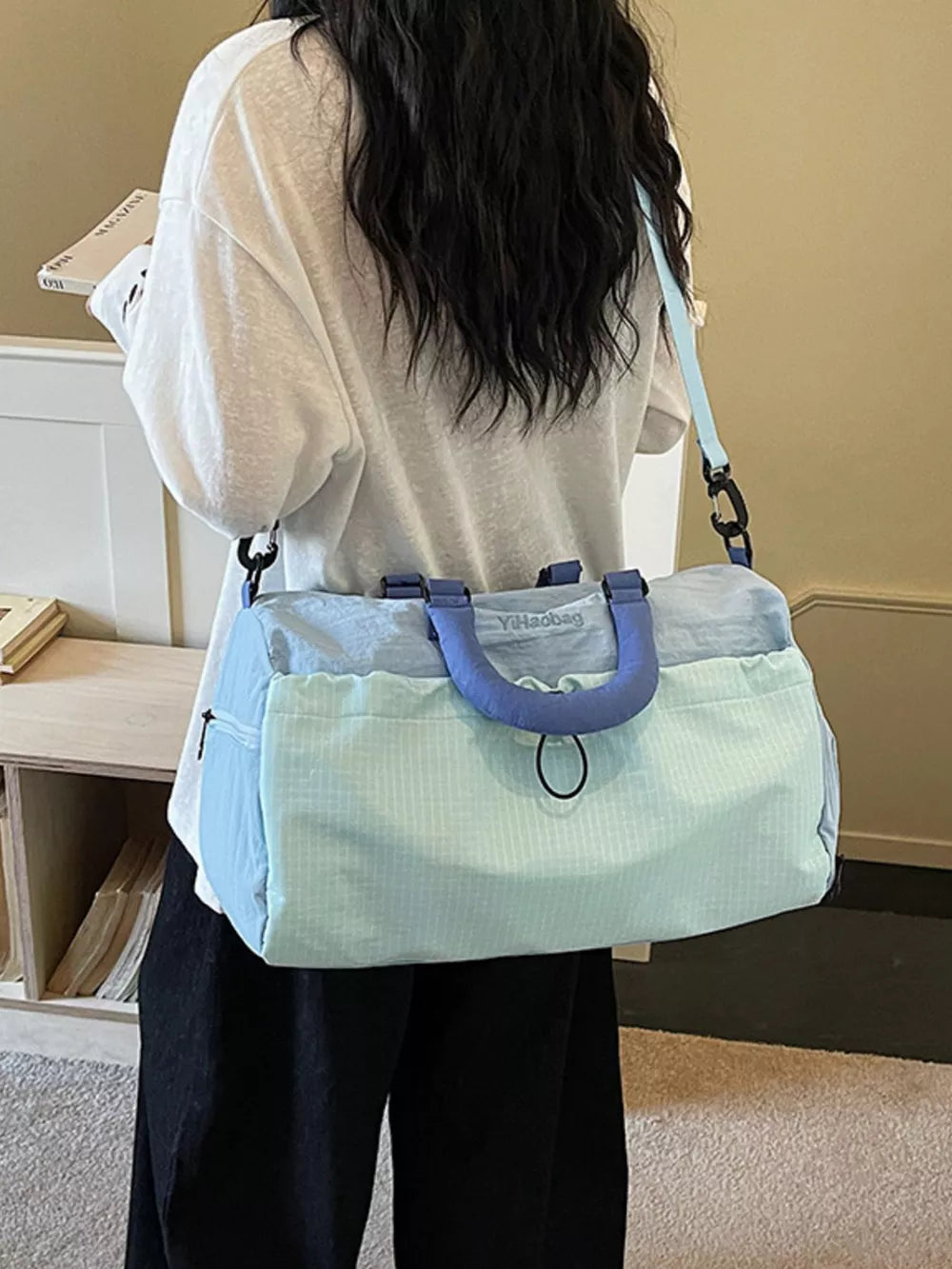 Light blue Oxford cloth travel bag with blue handles and strap, dual-tone design