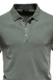 Sage green textured polo shirt with buttoned placket and spread collar.