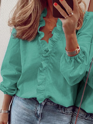 Teal blouse with cascading ruffle front and balloon sleeves.