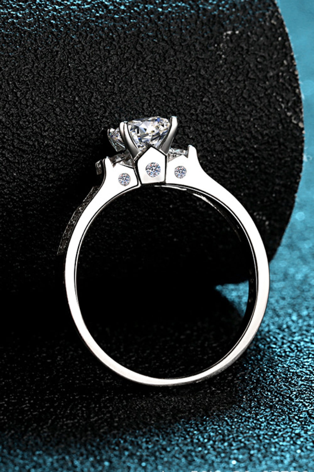 Silver rhodium engagement ring with a large solitaire diamond and pavé accents.