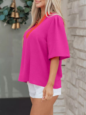 Textured hot pink V-neck blouse with orange trim and half sleeves.