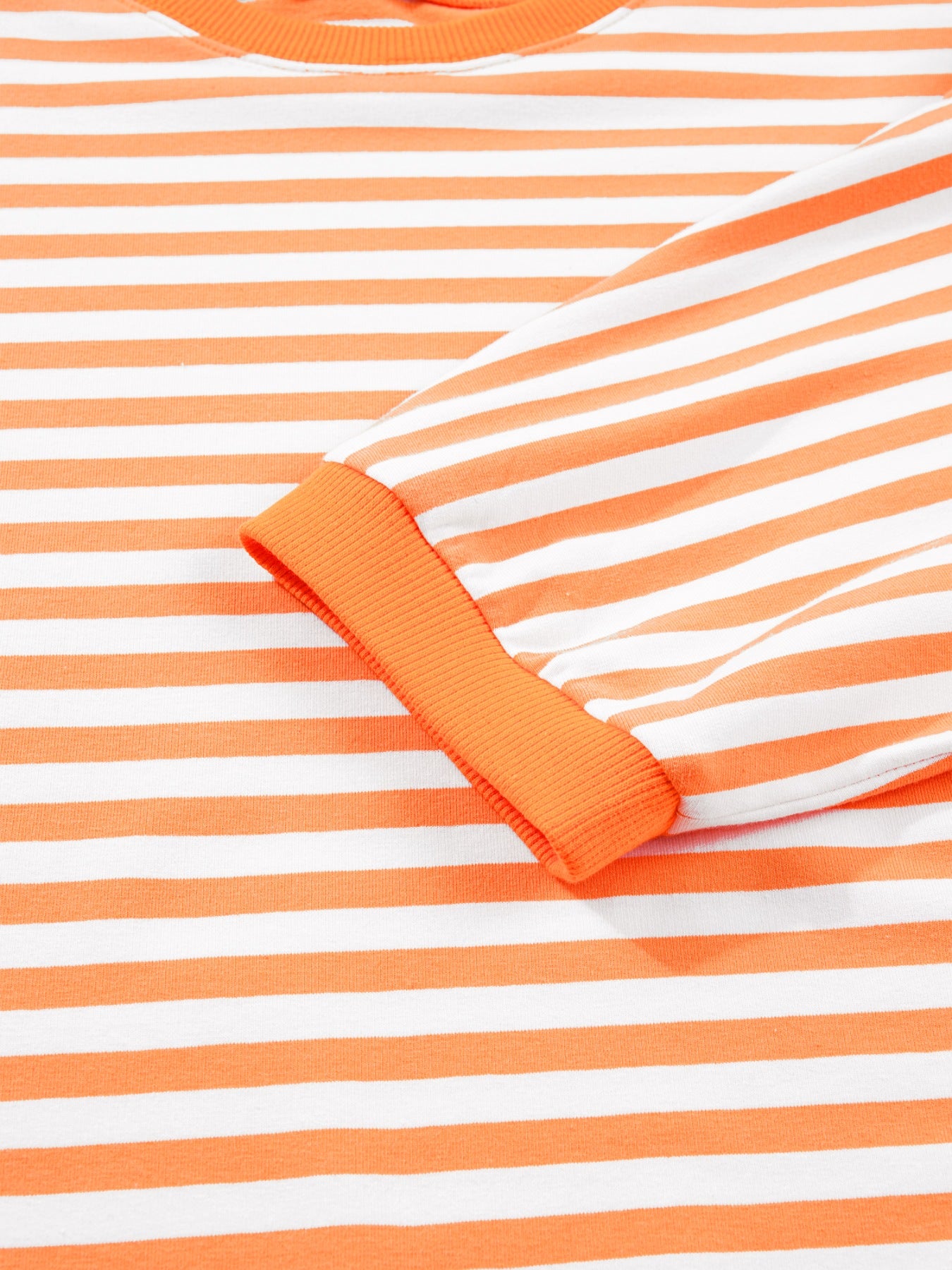 Oversized orange and white striped cotton t-shirt with 3/4 sleeves and ribbed cuffs.