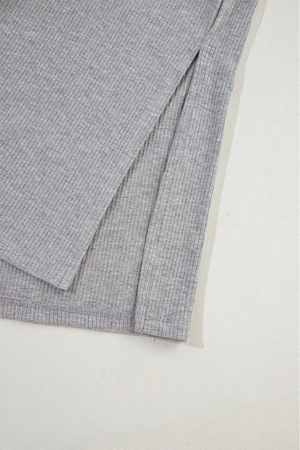 Gray ribbed knit lounge set detail showing a side slit on the garment.
