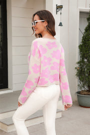Blush pink floral intarsia cropped knit sweater with crew neck and long sleeves.