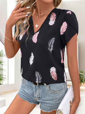 Black feather print blouse with puff sleeves and V-neck with button detail