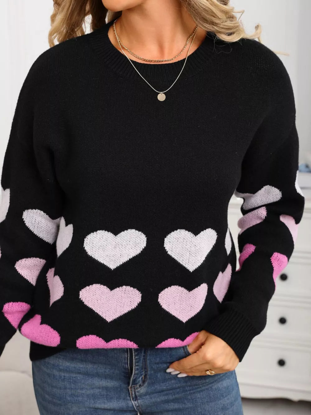 Black crew neck sweater with allover pink and white hearts, acrylic knit.