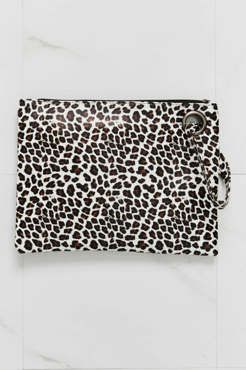 Leopard print wristlet pouch with metal ring detail and zipper closure.