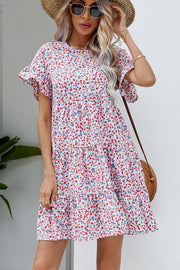 Miniature floral tiered babydoll dress with ruffled sleeves and a round neckline.