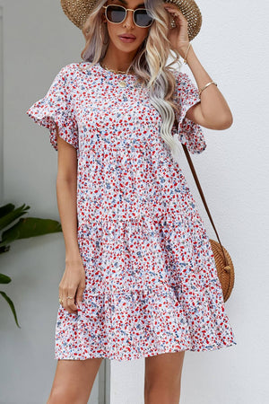 Miniature floral tiered babydoll dress with ruffled sleeves and a round neckline.